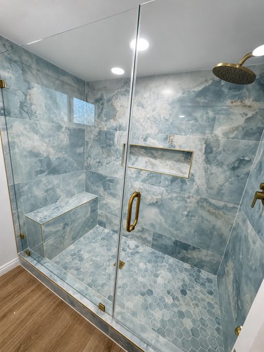 Blue stone shower with brass fixtures